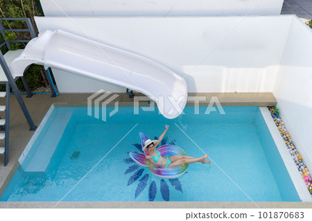 Woman in bikini with rubber inflatable float. Woman in swimsuit on the swim tube in swimming pool. Woman in bikini with rubber inflatable float. Woman in swimsuit on the swim tube in swimming pool. 101870683