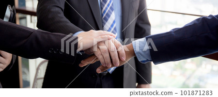 Closeup hands of group of business team harmony with man and woman and partner joining hands. Closeup hands of group of business team harmony with man and woman and partner joining hands. 101871283