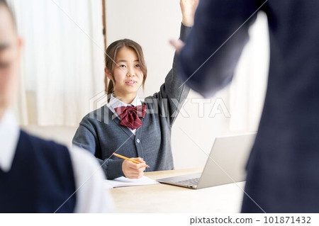 Female junior high school students in class raising their hands 101871432
