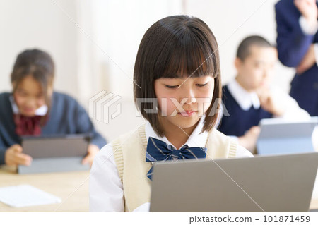 Female junior high school student in class staring at the PC screen Female junior high school student in class staring at the PC screen 101871459
