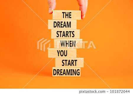 Start dreaming symbol. Concept words The dream starts when you start dreaming on wooden blocks. Beautiful orange background. Copy space. Businessman hand. Motivational business start dreaming concept. Start dreaming symbol. Concept words The dream starts when you start dreaming on wooden blocks. Beautiful orange background. Copy space. Businessman hand. Motivational business start dreaming concept. 101872044