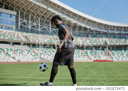 Professional football player in action at the stadium. The concept of sport, competition, movement, overcoming. The effect of the presence of the field. 101872471