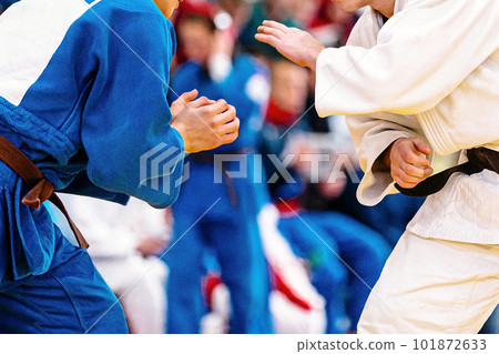 two judoists in blue and white kimono stand opposite each other, judo fight championship two judoists in blue and white kimono stand opposite each other, judo fight championship 101872633