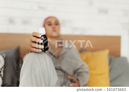Young woman with cancer taking pills, cancer awareness concept. 101873683