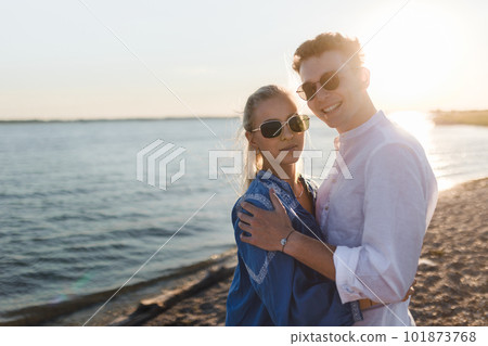 Young cupple cuddling during sunset at sea. 101873768