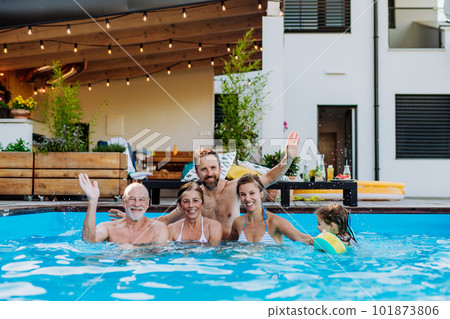 Portrait of happy multigenerational family enjoying summer time together in their swimming pool. Portrait of happy multigenerational family enjoying summer time together in their swimming pool. 101873806