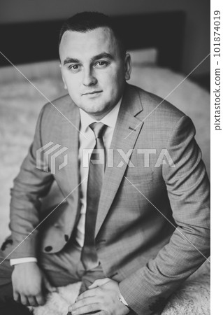 Young handsome man relaxing at his apartment in a hotel after business meeting 101874019