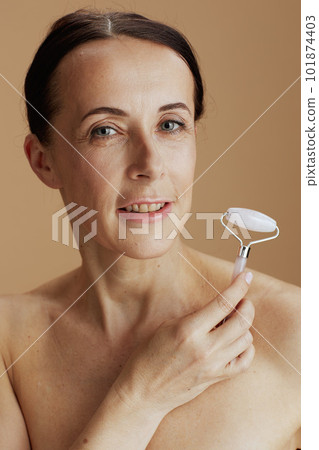 Portrait of modern woman against beige background 101874403