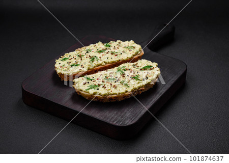 Grilled toast with avocado paste, eggs, cream cheese, salt, spices and herbs Grilled toast with avocado paste, eggs, cream cheese, salt, spices and herbs 101874637