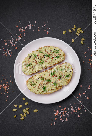 Grilled toast with avocado paste, eggs, cream cheese, salt, spices and herbs 101874679