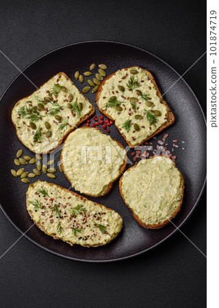 Grilled toast with avocado paste, eggs, cream cheese, salt, spices and herbs 101874719