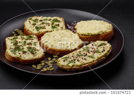 Grilled toast with avocado paste, eggs, cream cheese, salt, spices and herbs Grilled toast with avocado paste, eggs, cream cheese, salt, spices and herbs 101874721