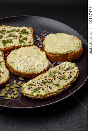Grilled toast with avocado paste, eggs, cream cheese, salt, spices and herbs 101874724