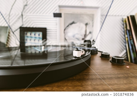 Vinyl record player, bright lights disco-bokeh. Needle on vinyl record. Vinyl record player, bright lights disco-bokeh. Needle on vinyl record. 101874836