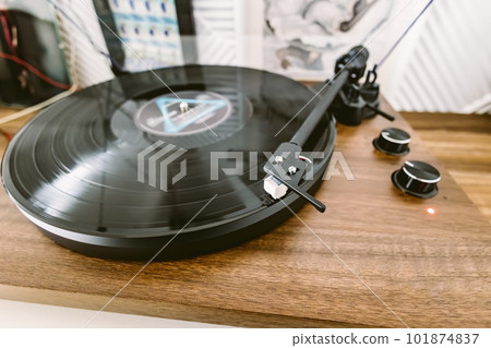 Vinyl record player, bright lights disco-bokeh. Needle on vinyl record. Vinyl record player, bright lights disco-bokeh. Needle on vinyl record. 101874837
