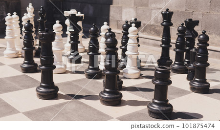 Giant chess on board located on ground outdoor - intellectual game 101875474