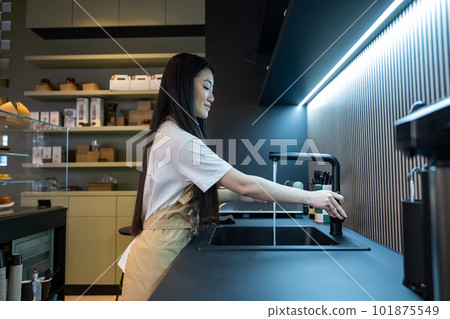 Coffee shop employee involved in washing her hands Coffee shop employee involved in washing her hands 101875549