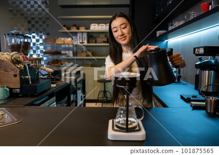 Concentrated young Asian barista brewing pour-over coffee Concentrated young Asian barista brewing pour-over coffee 101875565