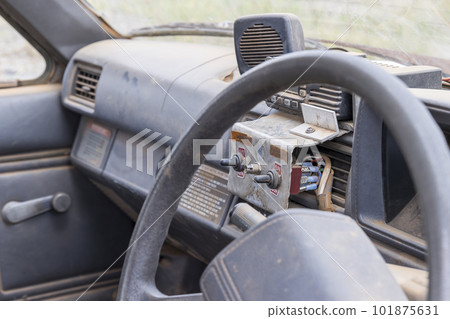 Looking through the window at the dashboard of a dirty old car 101875631
