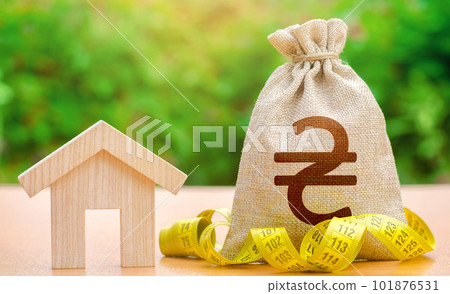 House figurine and ukrainian hryvnia money bag. Property valuation. Building maintenance. Mortgage loan calculation. Cost of home services, utilities. Energy efficiency. Real estate appraisal. House figurine and ukrainian hryvnia money bag. Property valuation. Building maintenance. Mortgage loan calculation. Cost of home services, utilities. Energy efficiency. Real estate appraisal. 101876531