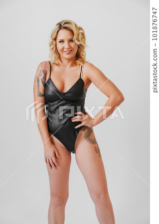 a sexy blonde with tattoos in a leather swimsuit a sexy blonde with tattoos in a leather swimsuit 101876747