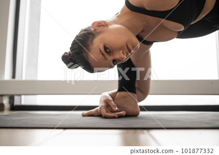 Fitness woman stretching legs on yoga mat in studio Fitness woman stretching legs on yoga mat in studio 101877332