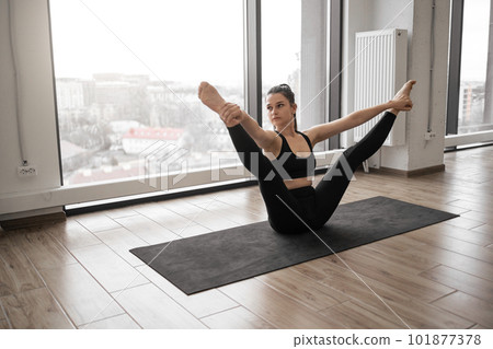 Flexible woman performing exercises for body stretching 101877378