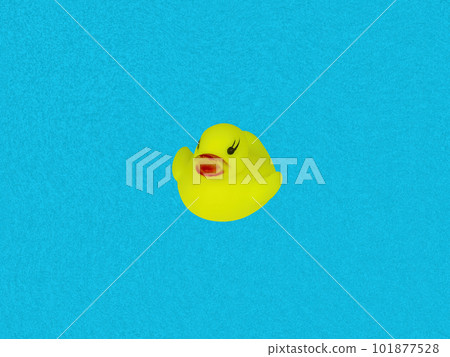 Children's toy bird yellow duckling on a blue background of water. Children's toy bird yellow duckling on a blue background of water. 101877528
