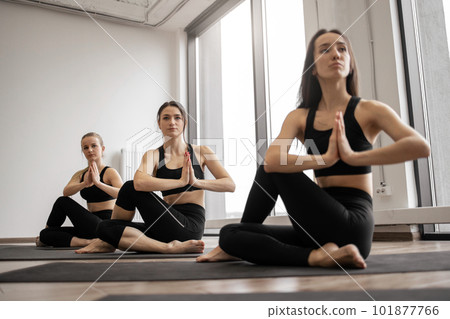 Ladies meditating in seated pose with hands in anjali mudra 101877766