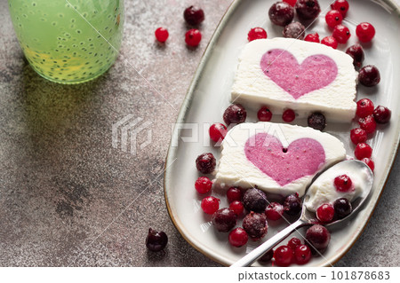 delicious ice cream with berry heart filling in middle and chia seeds water. healthy summer dessert. close-up delicious ice cream with berry heart filling in middle and chia seeds water. healthy summer dessert. close-up 101878683