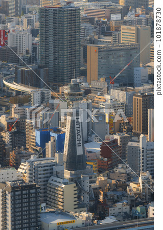 Tsutenkaku tower under renovation and the cityscape of Osaka illuminated by the setting sun 101878730