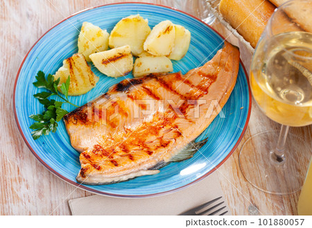 Roasted trout fillet with potatoes 101880057