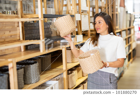 Latino american woman choosing wicker baskets in shop 101880270