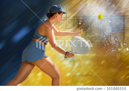 Determined sporty young woman doing her best playing padel in court Determined sporty young woman doing her best playing padel in court 101880333