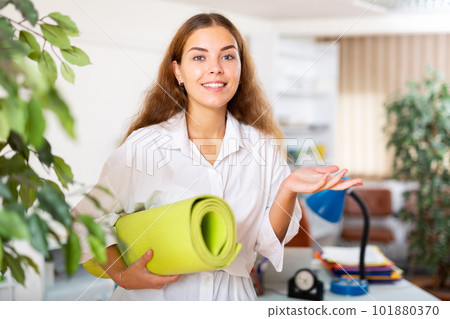 Young female office worker taking break for practicing yoga Young female office worker taking break for practicing yoga 101880370