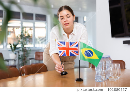 female assistant prepares conference room for diplomats of Brazil and Great Britain 101880557
