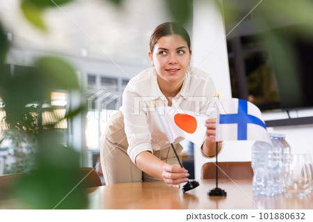 female assistant prepares conference room for diplomats of Finland and Japan 101880632