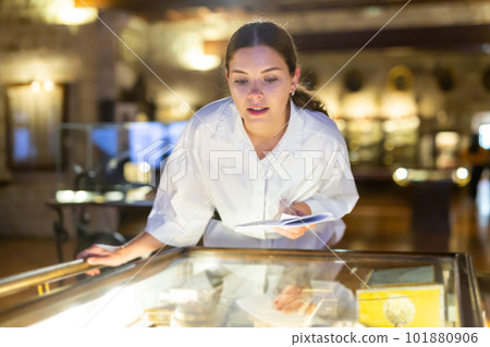 Woman looking at the exposition of mediaeval boxes Woman looking at the exposition of mediaeval boxes 101880906