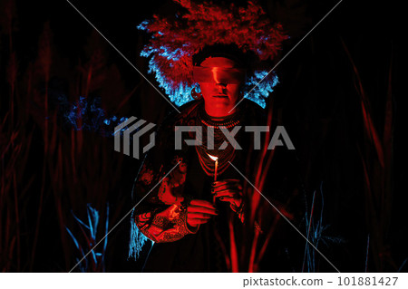 Ukrainian woman as motanka with candle. Ribbon around eyes as on ritual rag doll Ukrainian woman as motanka with candle. Ribbon around eyes as on ritual rag doll 101881427