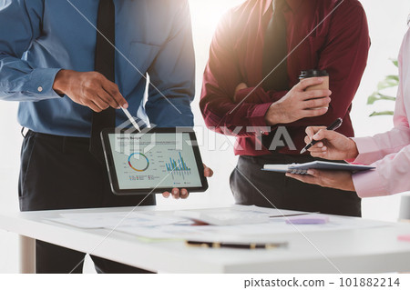 Close up of Diverse colleagues gather brainstorm discuss financial statistics at office meeting. finance, teamwork, Big data Graphs Charts concept 101882214