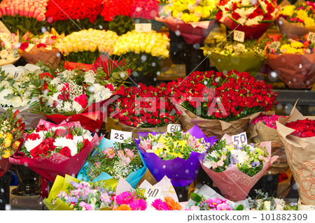 Colorful roses bouquet display in front of flower shop. Flower arrangements for sale at local market Colorful roses bouquet display in front of flower shop. Flower arrangements for sale at local market 101882309