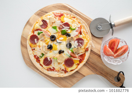 Milanese-style pizza with a thin crust Milanese-style pizza with a thin crust 101882776