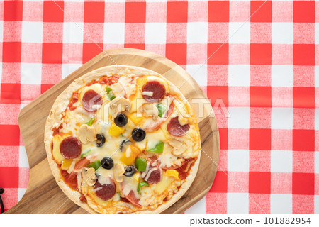 Milanese-style pizza with a thin crust Milanese-style pizza with a thin crust 101882954