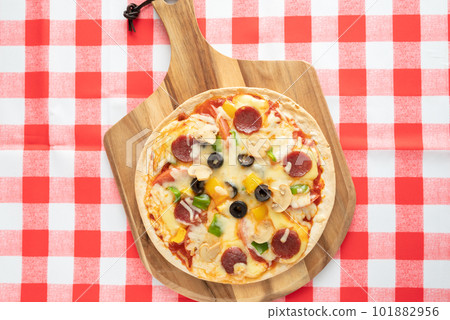 Milanese-style pizza with a thin crust Milanese-style pizza with a thin crust 101882956