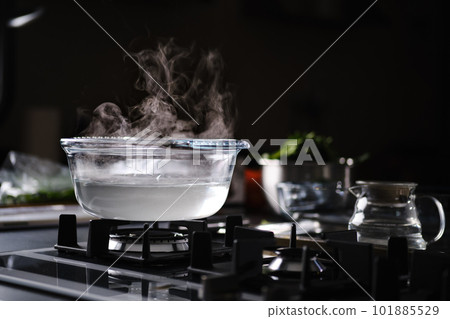 Hot water in pot on gas stove Hot water in pot on gas stove 101885529
