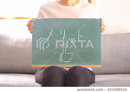 Woman with merit blackboard 101886816