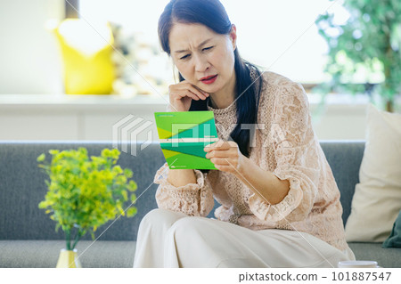 A woman who falls down looking at a passbook A woman who falls down looking at a passbook 101887547