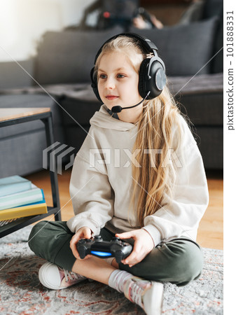 Little girl playing on games console 101888331