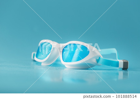 White swimming goggles on a blue background White swimming goggles on a blue background 101888514