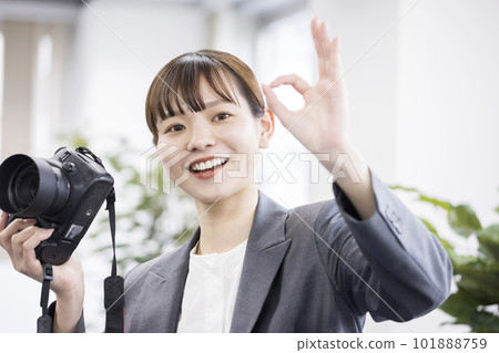 Female photographer shooting image giving OK to the model 101888759